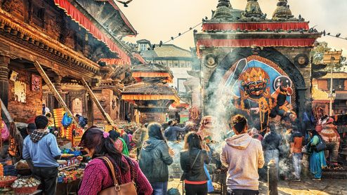 A colorful temple in Kathmandu that is visited by many people.