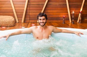 man with cheeky grin in thermotherapy pool