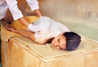 woman covered in bubbles during a hydrotherapy wash