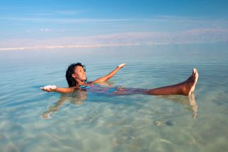 Woman Swimming the Dead Sea Salt Water